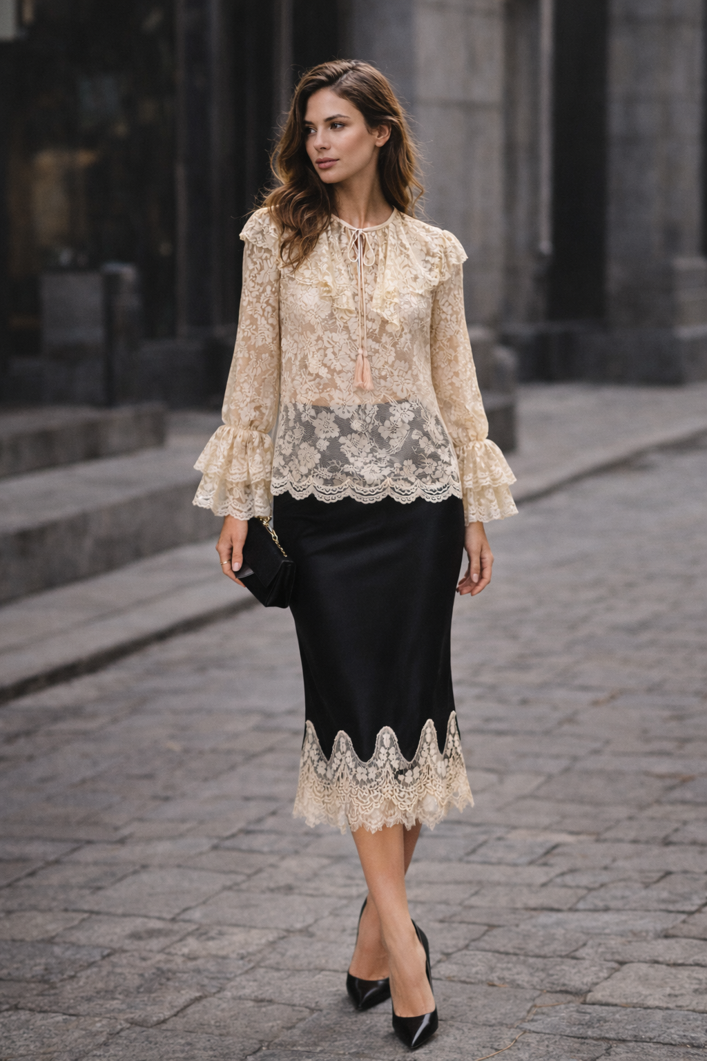 Woman wearing a lace blouse and black skirt on a stone pavement.