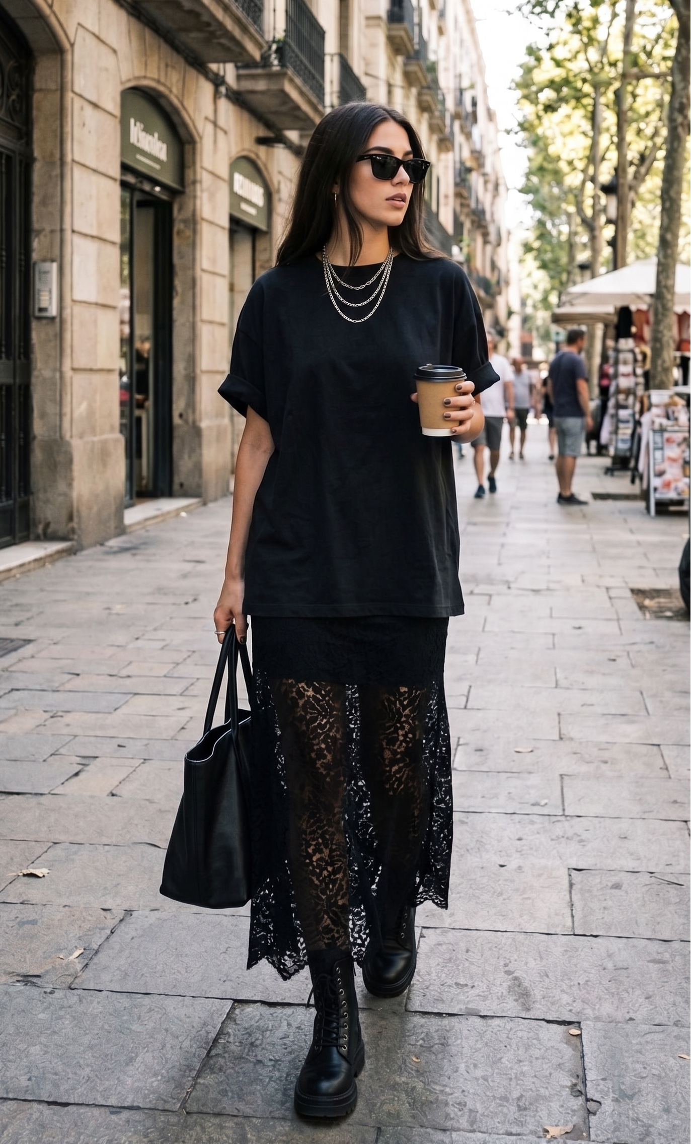 Woman in black outfit with lace skirt walking on a city street.