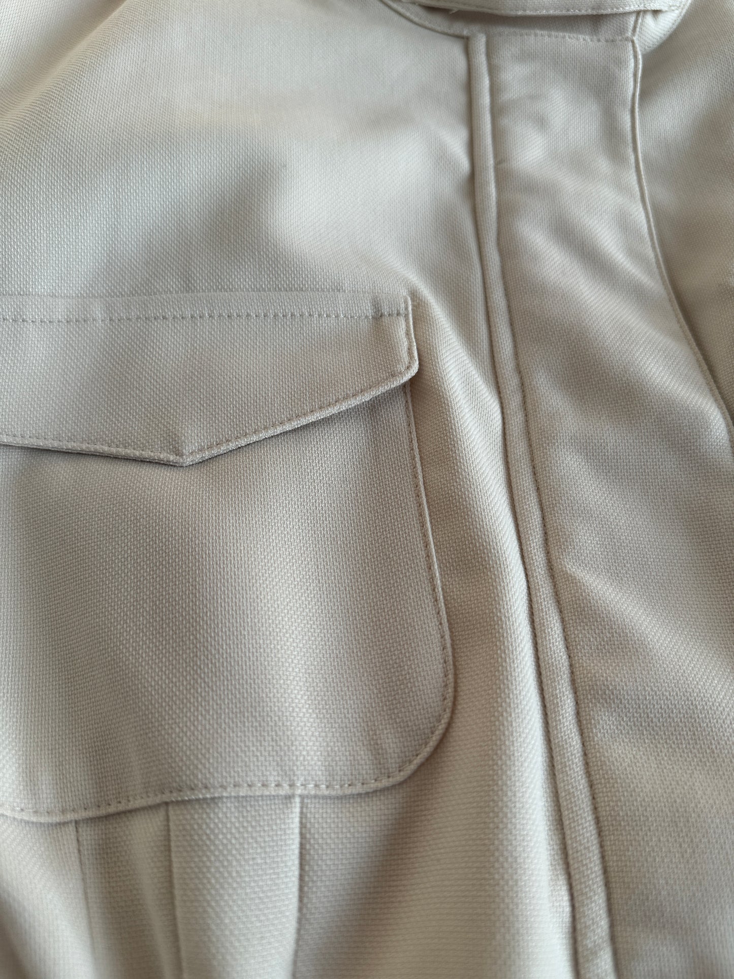 Close-up of a beige jacket with a pocket