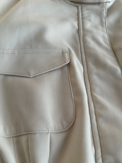Close-up of a beige jacket with a pocket