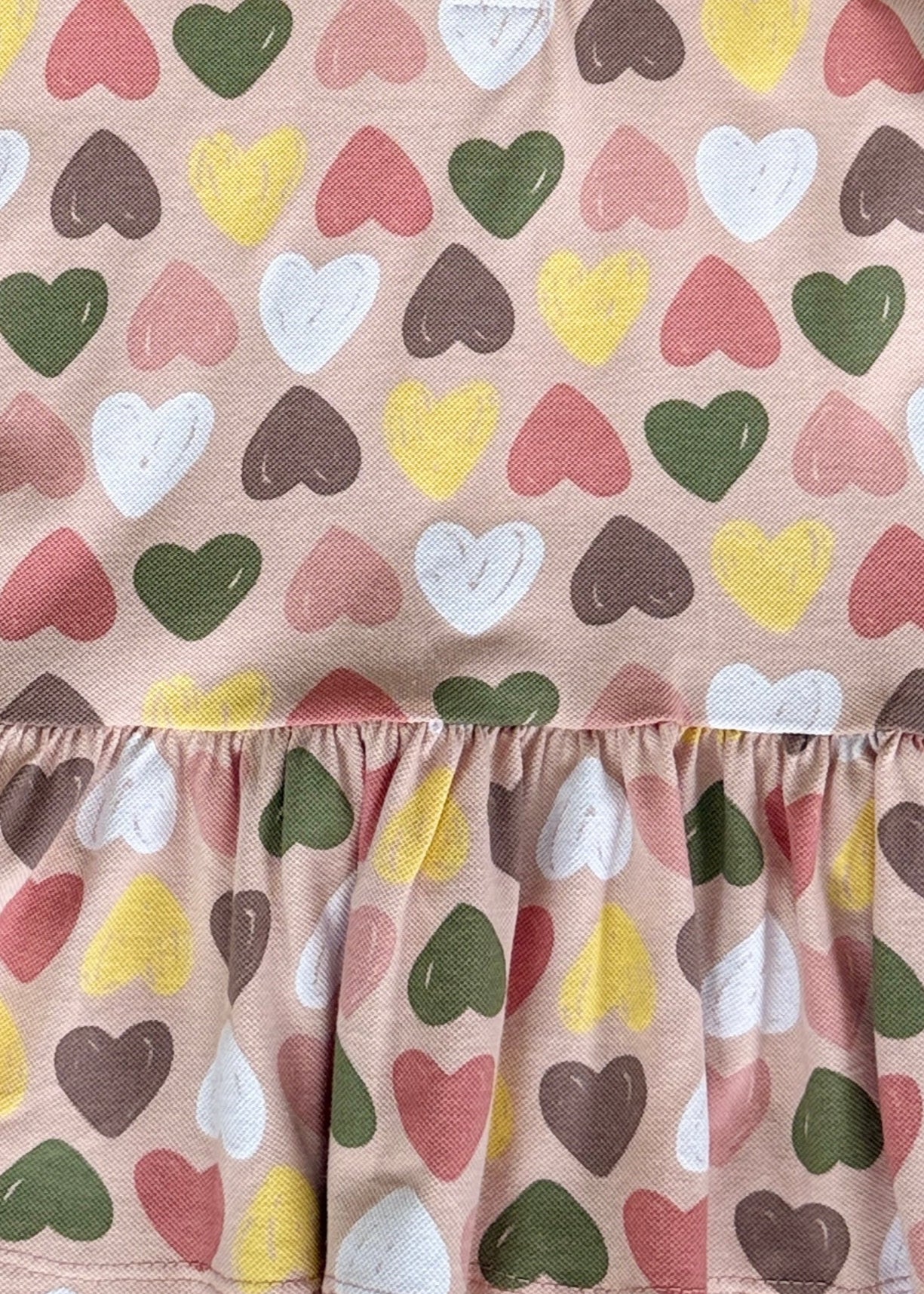 Fabric with colorful heart pattern on a beige background