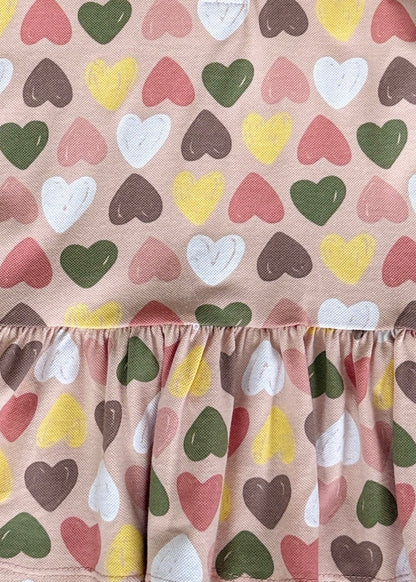 Fabric with colorful heart pattern on a beige background