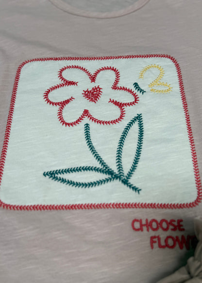 Embroidered flower design on a white shirt with text 'CHOOSE FLOW'.