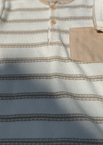 Close-up of a striped shirt with a pocket and buttons.