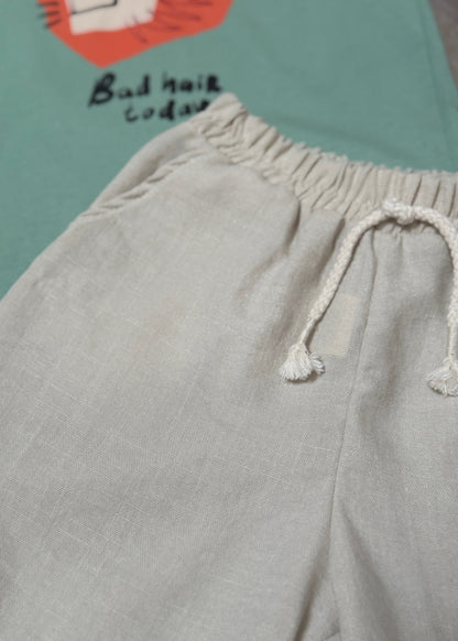 Gray sweatpants with a drawstring on a green background