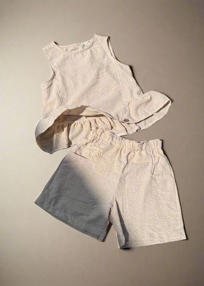 Light-colored sleeveless top and shorts set on a beige background