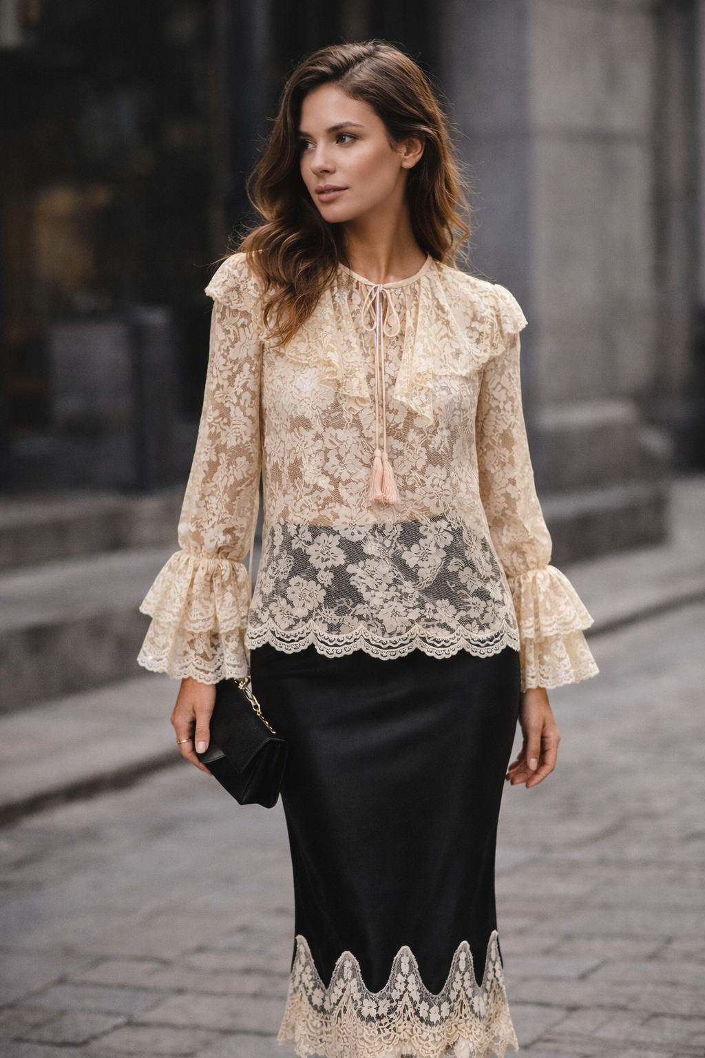 Woman wearing a lace blouse and black skirt with a blurred background