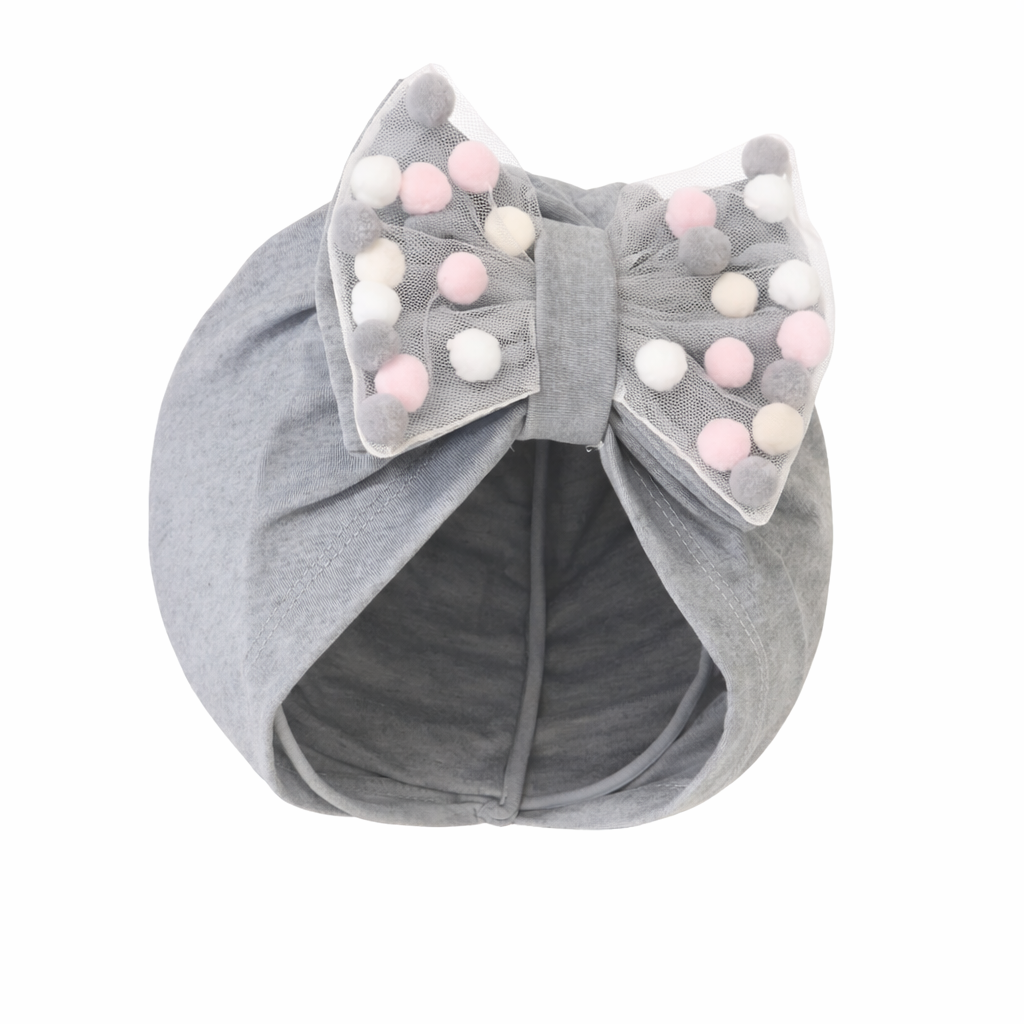 Gray baby turban with a large bow and pom-poms on a white background