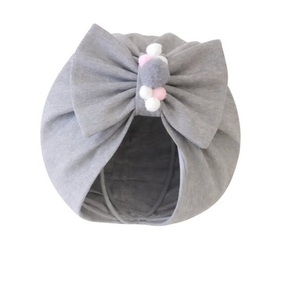 Gray headband with a bow and colorful beads on a white background