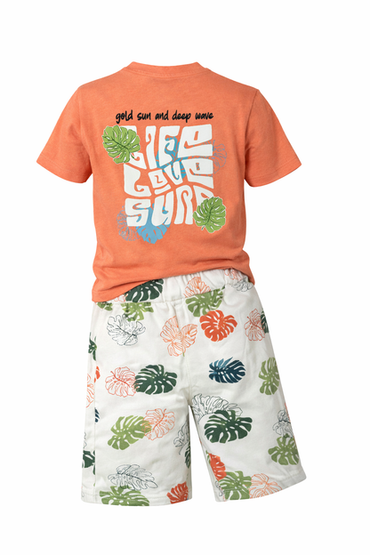 Children's outfit with orange t-shirt and white shorts with colorful leaf pattern on a white background
