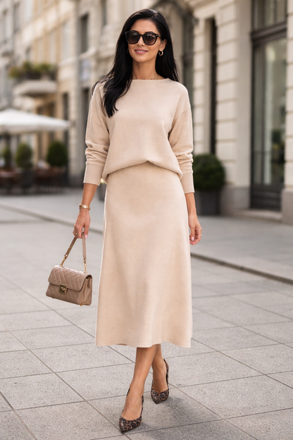 Woman in a beige outfit walking on a city street.